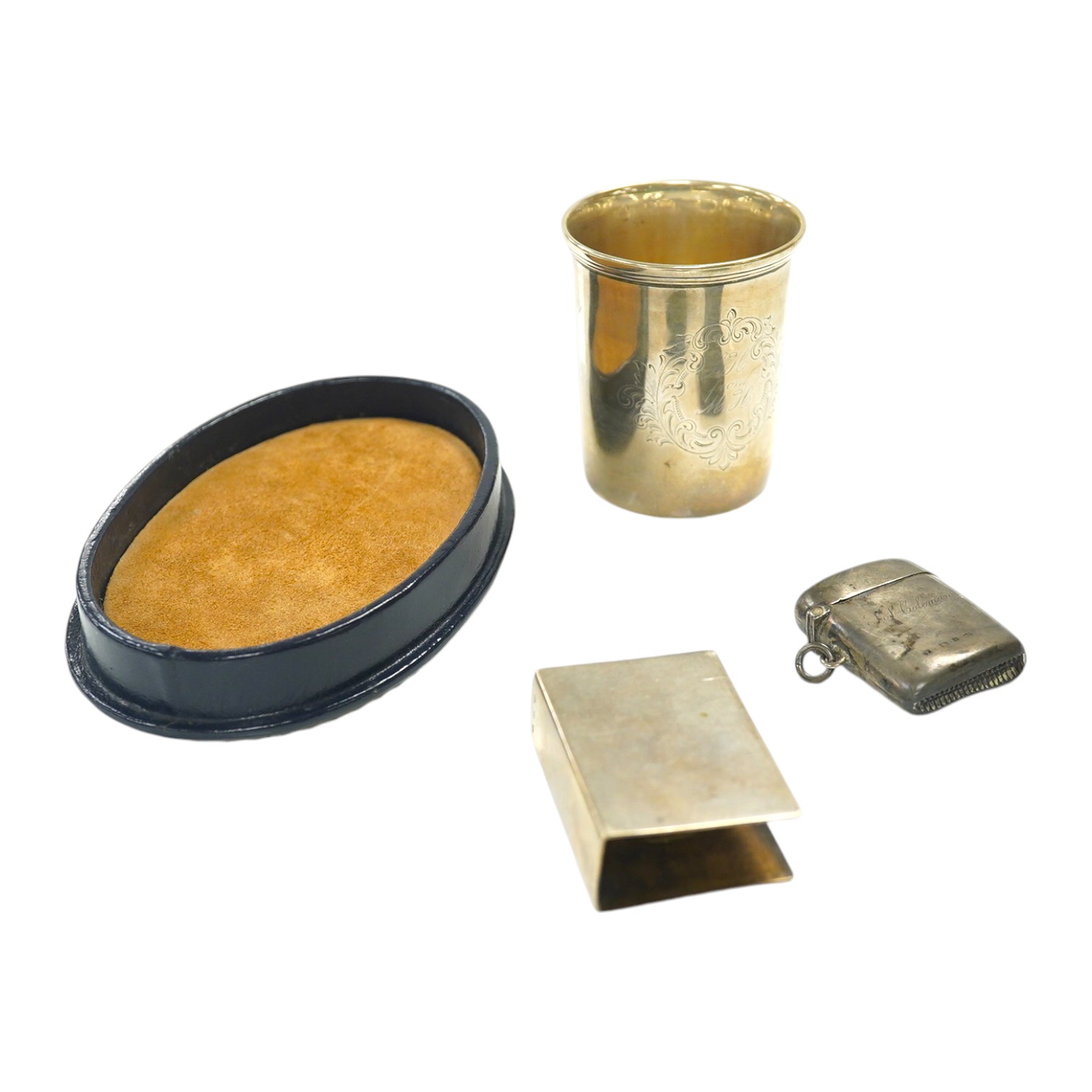 An Austrian 800 standard white metal matchbox holder, a 19th century continental white metal beaker, a modern silver mounted box cover and a silver vesta case. Condition - poor to fair